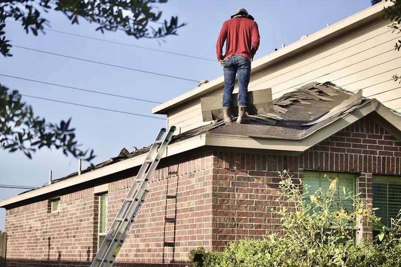 Professional roofer working on a residential roof in Old Englewood Village